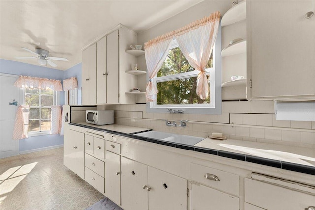 1120 Franklin St, Red Bluff, CA 96080 - kitchen featuring open shelves, ceiling fan, decorative backsplash, and plenty of natural light