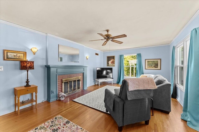 1120 Franklin St, Red Bluff, CA 96080 - living room featuring a ceiling fan, ornamental molding, a fireplace, and wood finished floors