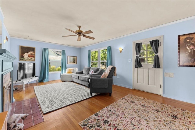 1120 Franklin St, Red Bluff, CA 96080 - living room with crown molding, plenty of natural light, ceiling fan, wood finished floors, and a fireplace