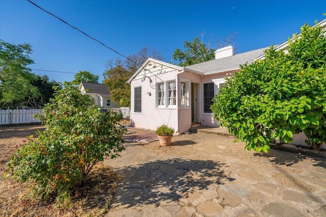1120 Franklin St, Red Bluff, CA 96080 - view of home's exterior with stucco siding and a chimney