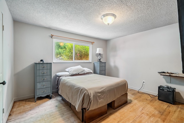 19078 Gravel Plant Rd, Redding, CA 96002 - bedroom with light wood-type flooring and a textured ceiling