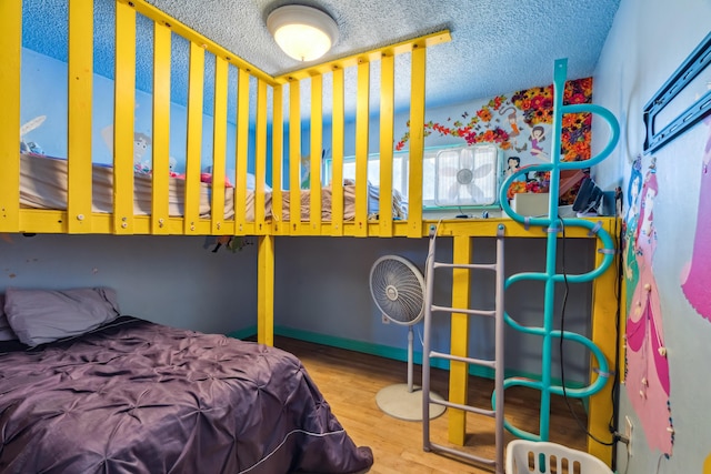 19078 Gravel Plant Rd, Redding, CA 96002 - bedroom with wood finished floors, a textured ceiling, and multiple windows