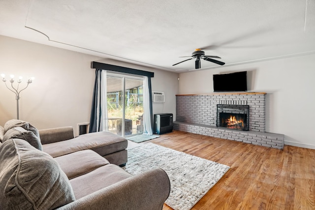 19078 Gravel Plant Rd, Redding, CA 96002 - living area with ceiling fan, wood finished floors, a brick fireplace, and an AC wall unit