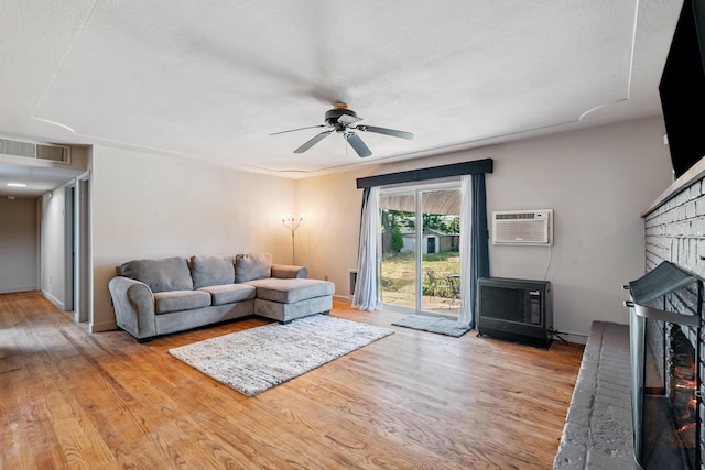 19078 Gravel Plant Rd, Redding, CA 96002 - living room with a fireplace, a wall unit AC, wood finished floors, ceiling fan, and heating unit