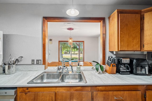 19078 Gravel Plant Rd, Redding, CA 96002 - kitchen featuring light countertops, brown cabinetry, and pendant lighting