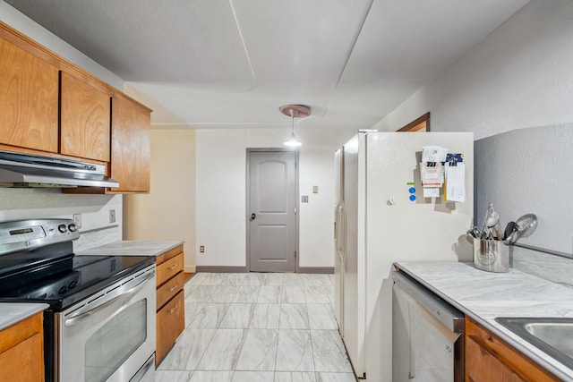 19078 Gravel Plant Rd, Redding, CA 96002 - kitchen featuring appliances with stainless steel finishes, under cabinet range hood, light marble finish floors, brown cabinets, and light countertops