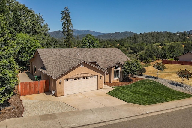 2926 Chaucer Way, Shasta Lake, CA 96019 - ranch-style home featuring stucco siding, a garage, concrete driveway, a wooded view, and a mountain view