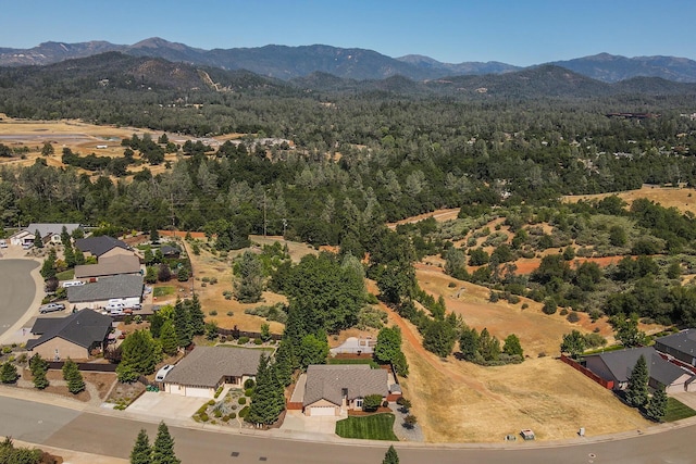 2926 Chaucer Way, Shasta Lake, CA 96019 - aerial perspective of suburban area featuring a mountainous background and a heavily wooded area