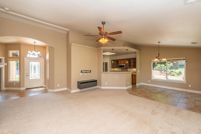 2926 Chaucer Way, Shasta Lake, CA 96019 - unfurnished living room with light colored carpet, arched walkways, vaulted ceiling, light tile patterned flooring, and ceiling fan