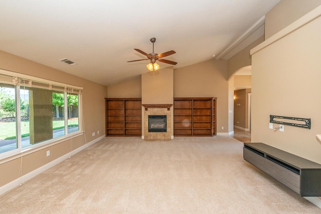 2926 Chaucer Way, Shasta Lake, CA 96019 - unfurnished living room featuring vaulted ceiling, a ceiling fan, light carpet, a fireplace, and arched walkways