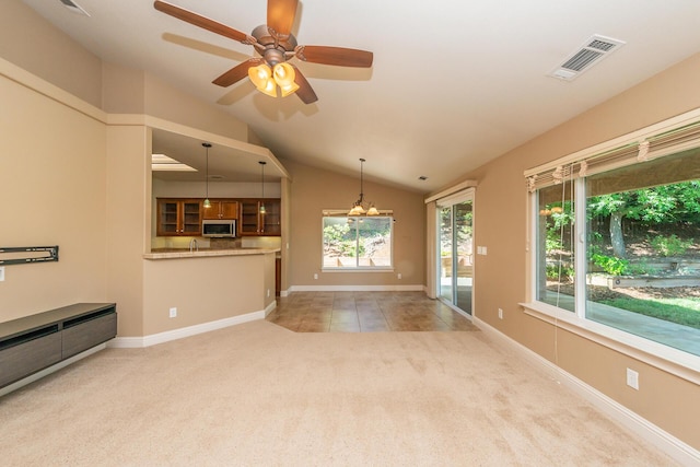2926 Chaucer Way, Shasta Lake, CA 96019 - unfurnished living room with light carpet, lofted ceiling, a ceiling fan, a chandelier, and light tile patterned floors