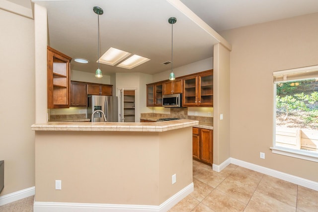 2926 Chaucer Way, Shasta Lake, CA 96019 - kitchen with stainless steel appliances, brown cabinets, open shelves, and a peninsula