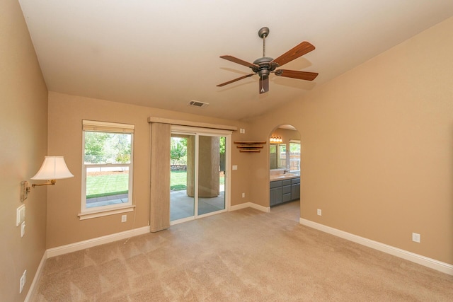 2926 Chaucer Way, Shasta Lake, CA 96019 - spare room with vaulted ceiling, arched walkways, plenty of natural light, light colored carpet, and ceiling fan