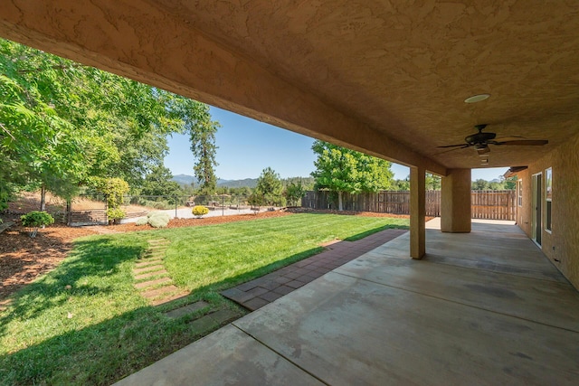 2926 Chaucer Way, Shasta Lake, CA 96019 - fenced backyard featuring a ceiling fan, a patio, and a mountain view