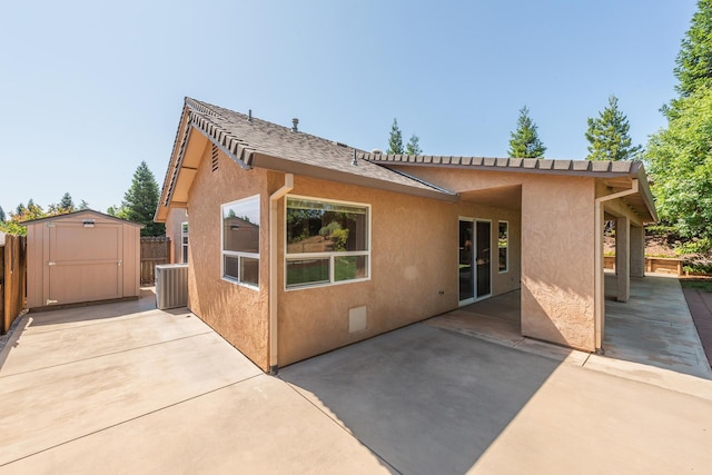 2926 Chaucer Way, Shasta Lake, CA 96019 - rear view of house featuring stucco siding, a storage unit, and a patio area