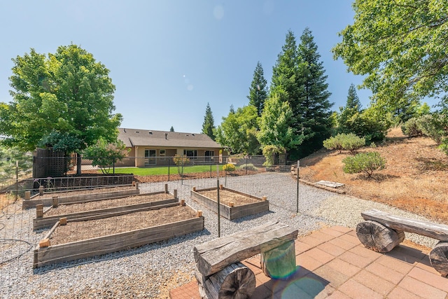 2926 Chaucer Way, Shasta Lake, CA 96019 - view of yard featuring a vegetable garden and a patio area