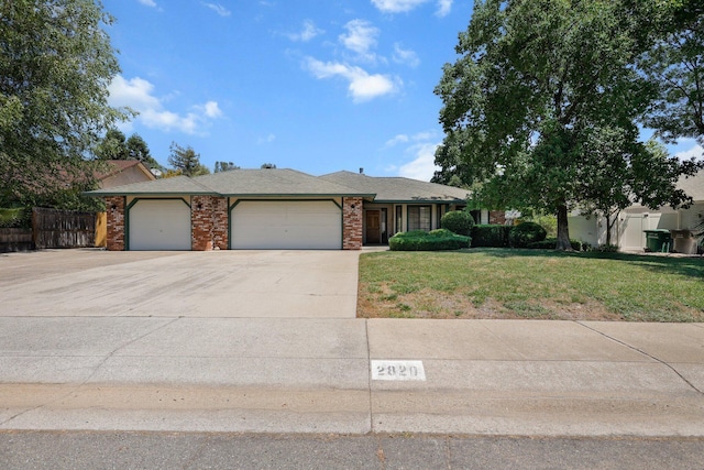 2820 Howard Dr, Redding, CA 96001 - view of front of house with a garage, concrete driveway, and brick siding
