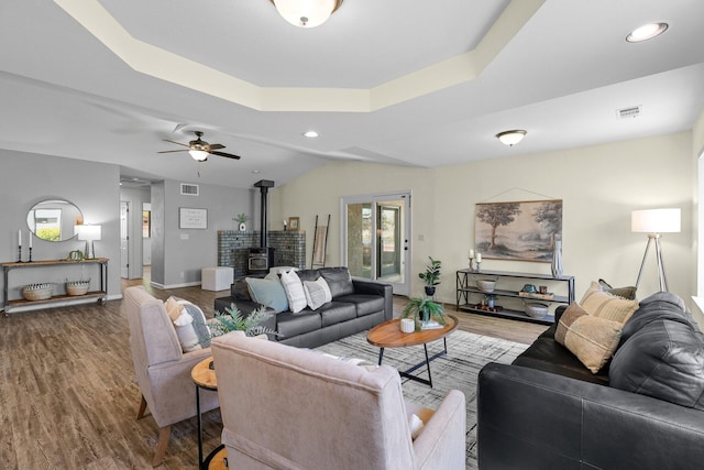 2820 Howard Dr, Redding, CA 96001 - living area featuring a wood stove, wood finished floors, a tray ceiling, recessed lighting, and ceiling fan