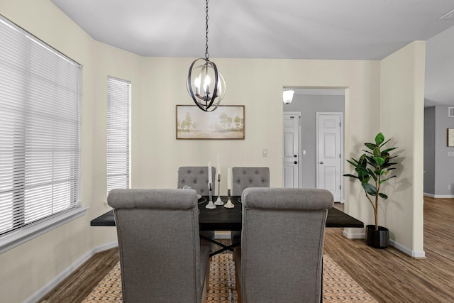 2820 Howard Dr, Redding, CA 96001 - dining area featuring wood finished floors and a chandelier