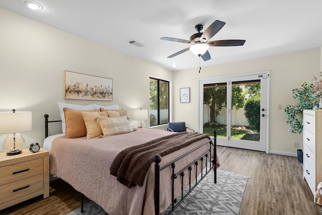 2820 Howard Dr, Redding, CA 96001 - bedroom with access to outside, wood finished floors, multiple windows, and a ceiling fan