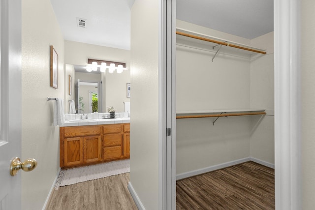 2820 Howard Dr, Redding, CA 96001 - full bath featuring wood finished floors, double vanity, and a walk in closet