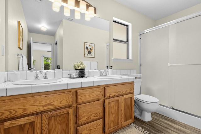 2820 Howard Dr, Redding, CA 96001 - bathroom with wood finished floors, double vanity, and a stall shower