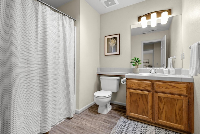 2820 Howard Dr, Redding, CA 96001 - full bathroom featuring wood finished floors, vanity, and curtained shower