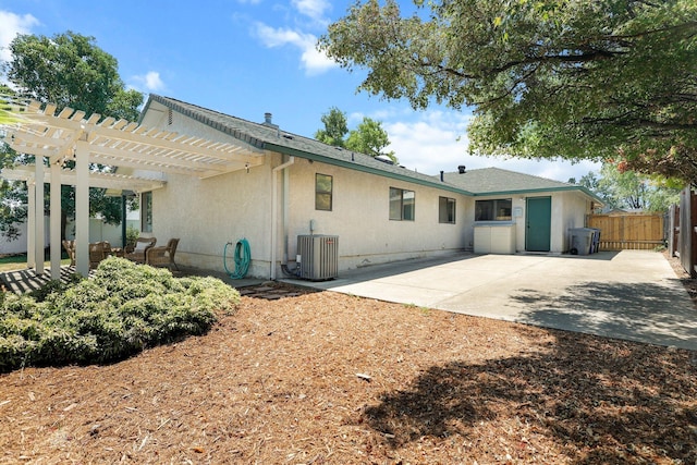 2820 Howard Dr, Redding, CA 96001 - back of house with a pergola, a patio area, and stucco siding