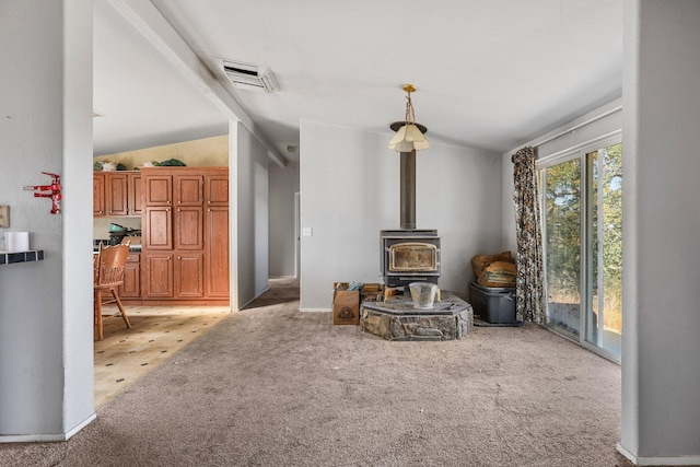 3287 Yolla Bolly Rd, Igo, CA 96047 - living room with light carpet, a wood stove, and lofted ceiling
