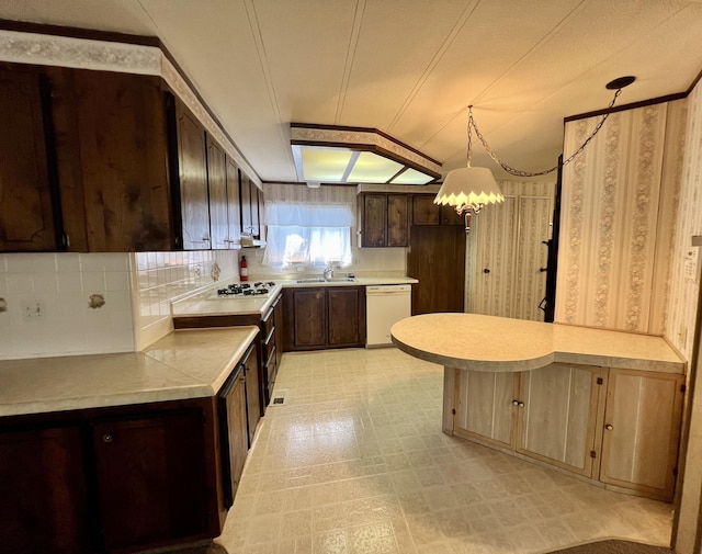 4784 White River Dr, Redding, CA 96003 - kitchen featuring white appliances, dark brown cabinetry, light countertops, light flooring, and a peninsula