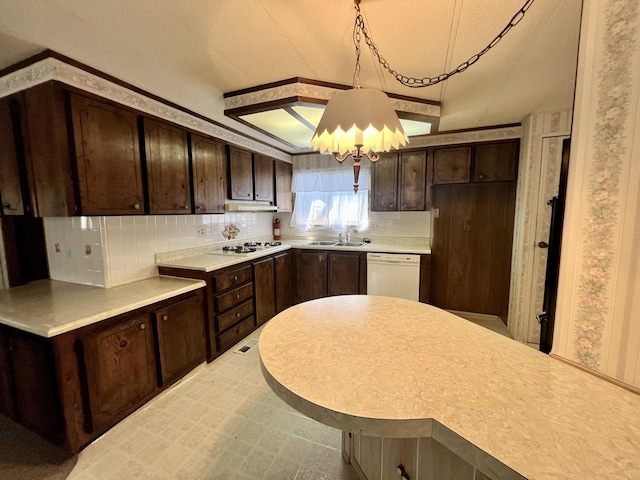 4784 White River Dr, Redding, CA 96003 - kitchen with dark brown cabinets, white appliances, tasteful backsplash, light countertops, and under cabinet range hood