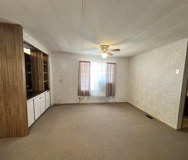 4784 White River Dr, Redding, CA 96003 - unfurnished living room featuring carpet flooring, a ceiling fan, and wallpapered walls