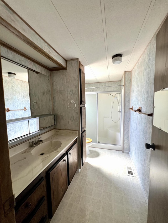 4784 White River Dr, Redding, CA 96003 - bathroom featuring vanity, a stall shower, and wallpapered walls