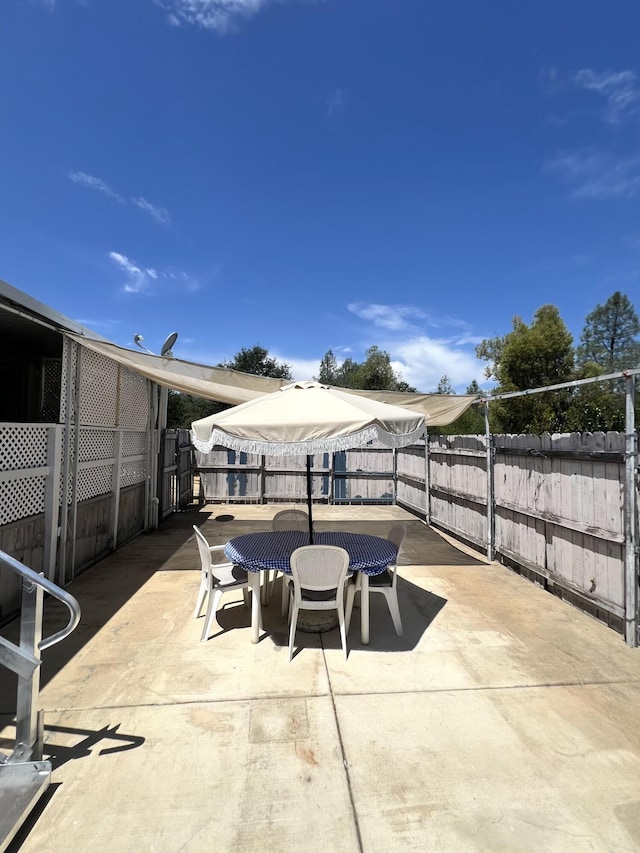 4784 White River Dr, Redding, CA 96003 - fenced backyard featuring outdoor dining area and a patio