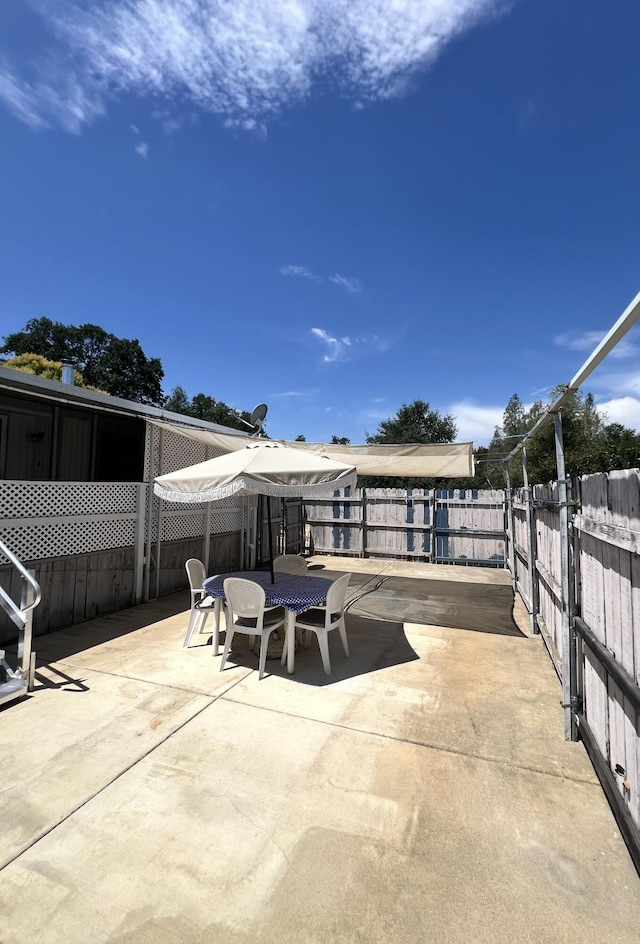 4784 White River Dr, Redding, CA 96003 - fenced backyard with a patio area and outdoor dining space