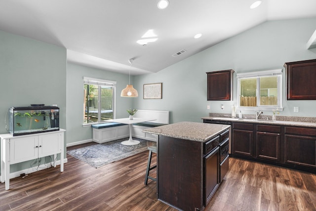 3525 Humbug Dr, Anderson, CA 96007 - kitchen with lofted ceiling, dark wood-style floors, a kitchen breakfast bar, a center island, and decorative light fixtures