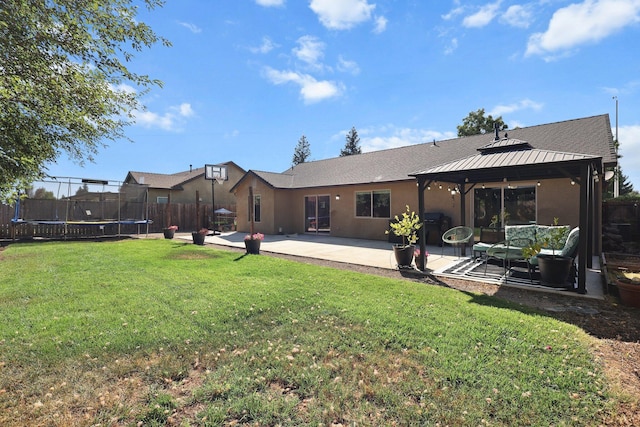 3525 Humbug Dr, Anderson, CA 96007 - back of house featuring a trampoline, a patio area, a gazebo, and stucco siding