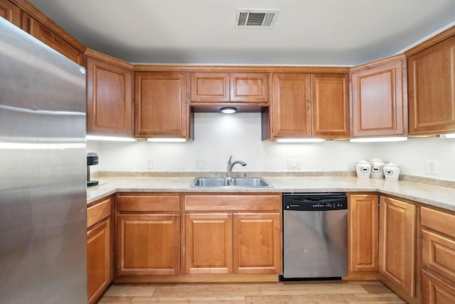 3351 Nicolet Ln, Redding, CA 96001 - kitchen with stainless steel appliances, light countertops, light wood finished floors, and brown cabinets