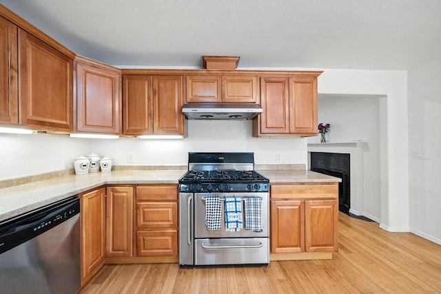 3351 Nicolet Ln, Redding, CA 96001 - kitchen with appliances with stainless steel finishes, under cabinet range hood, light wood finished floors, and light countertops