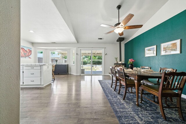 3385 Pioneer Ln, Redding, CA 96001 - dining room featuring wood finished floors, a ceiling fan, lofted ceiling, and a textured wall