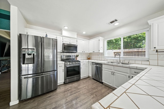 3385 Pioneer Ln, Redding, CA 96001 - kitchen with stainless steel appliances, tile countertops, decorative backsplash, dark wood finished floors, and recessed lighting