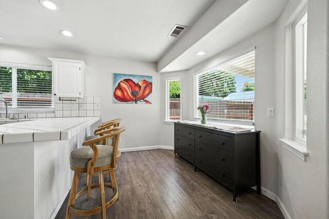 3385 Pioneer Ln, Redding, CA 96001 - kitchen with white cabinetry, dark wood-style floors, tile counters, recessed lighting, and tasteful backsplash