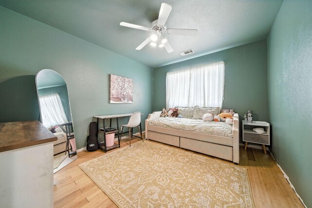 3385 Pioneer Ln, Redding, CA 96001 - bedroom featuring multiple windows, wood finished floors, vaulted ceiling, and a ceiling fan