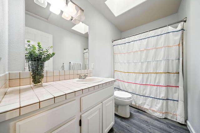 3385 Pioneer Ln, Redding, CA 96001 - bathroom featuring a skylight, wood finished floors, vanity, and a shower with shower curtain