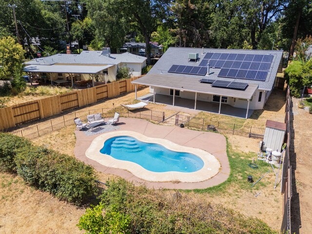 3385 Pioneer Ln, Redding, CA 96001 - view of swimming pool with a fenced backyard, a patio area, and view of wooded area