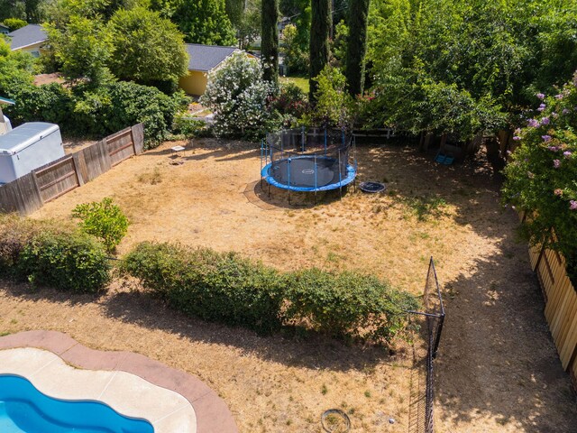 3385 Pioneer Ln, Redding, CA 96001 - fenced backyard featuring a trampoline