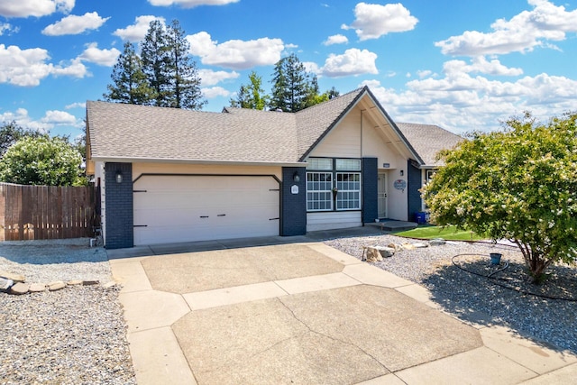 2773 Crystal Tree Dr, Redding, CA 96001 - view of front of home featuring an attached garage, concrete driveway, brick siding, and a shingled roof