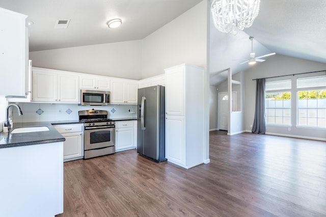 2773 Crystal Tree Dr, Redding, CA 96001 - kitchen featuring appliances with stainless steel finishes, dark countertops, ceiling fan, a chandelier, and white cabinetry