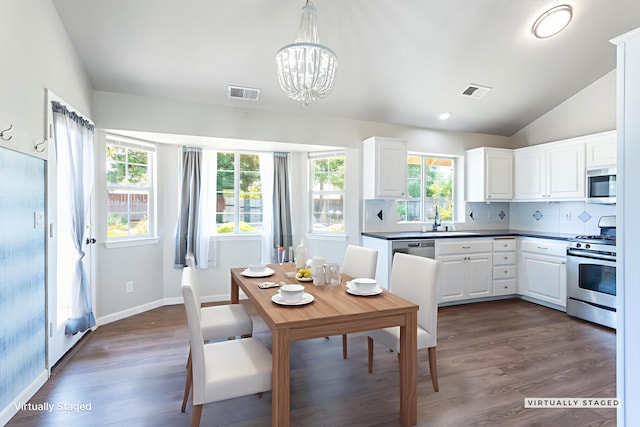 2773 Crystal Tree Dr, Redding, CA 96001 - dining space featuring a chandelier, healthy amount of natural light, dark wood-style flooring, lofted ceiling, and recessed lighting