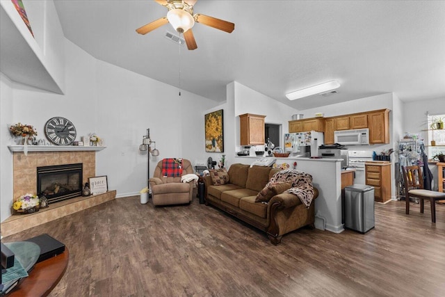 726 Stonebriar Trl, Redding, CA 96003 - living room with a ceiling fan, dark wood-type flooring, and a tiled fireplace